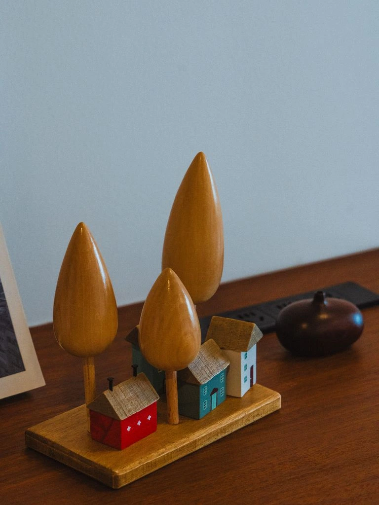 Quiet corner of the dining room in the early years — communal table, framed family photographs, late-afternoon light.