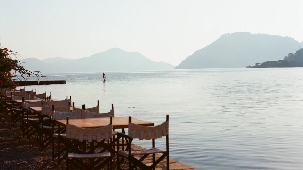 A table waiting at The Coppermine Pub, set against the lakeside view at dusk